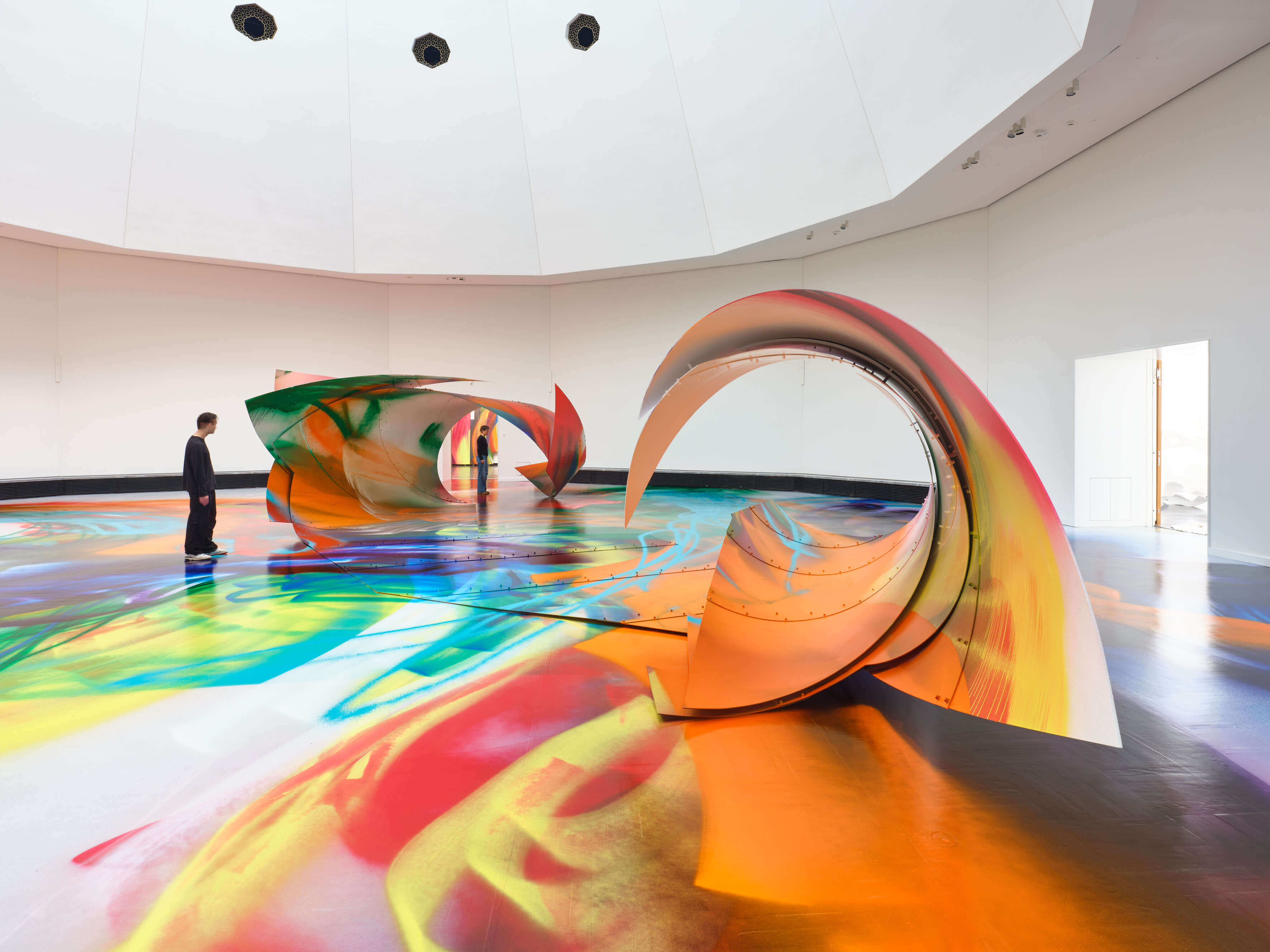Katharina Grosse painted installation Katharina Grosse installation covered in bright sprayed paint across walls and objects